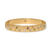 Gold bracelet with embedded crystals on a white background