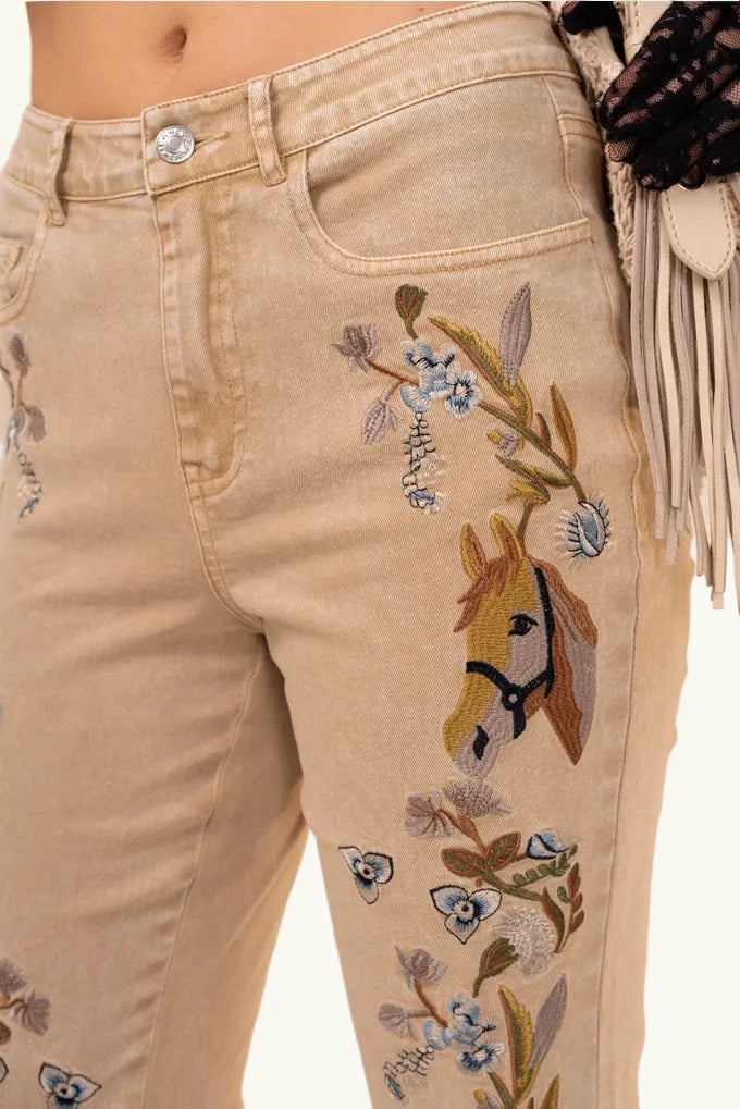 Beige pants with horse and floral embroidery on a beige background