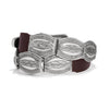 Silver belt buckle with intricate designs on a white background